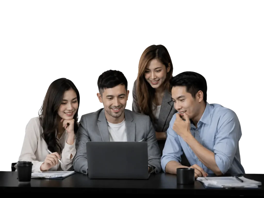 Four coworkers gathered around a laptop at a table